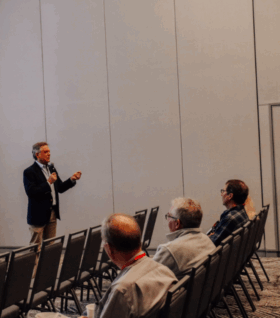Mark Ogland-Hand speaks to the 2025 Michigan Lakes & Streams Association audience about fundraising