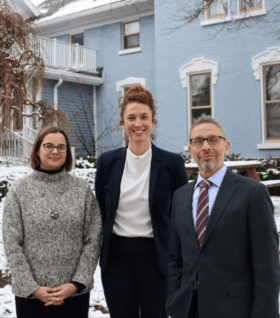 Megan Tinsley, Katie Garvey and Rob Michaels stand in fron the Michigan Environmental Council office in Lansing.