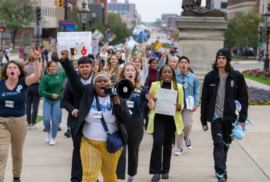 Protestors walk in downtown Lansing, calling for climate action. (Photo courtesy of Michigan Energy, Michigan Jobs)