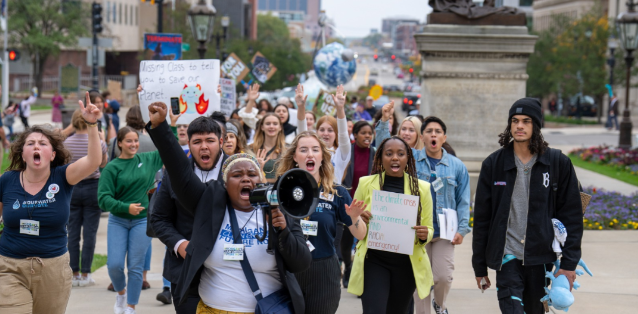 Protestors walk in downtown Lansing, calling for climate action. (Photo courtesy of Michigan Energy, Michigan Jobs)