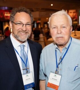 Conan Smith and Horst Schmidt pose for a photo at the 2023 annual event in Dearborn.