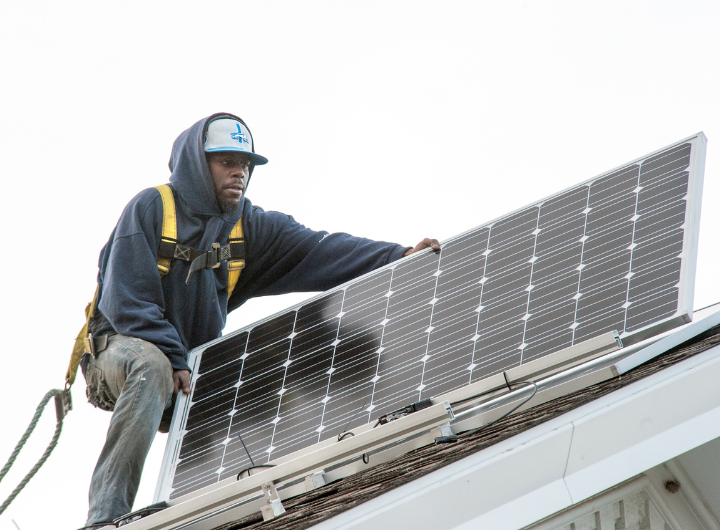 A man installs solar panels