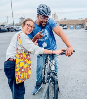 Galen Hardy balances on a bike next to Ellen Vial in Detroit.