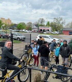 Staff smile for a photo after a bike ride through Detroit.