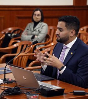 Megan Tinsley watches a lawmaker give testimony to a Michigan House committee.