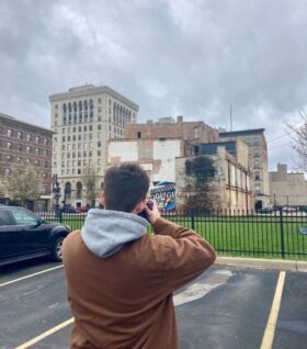 Nate Mathewson takes photos of a mural in Downtown Saginaw.