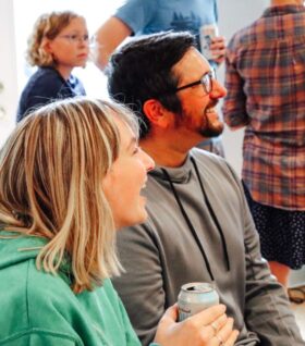 Abby Wallace and Ross Gavin smile during a wedding party.