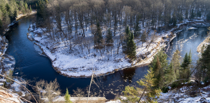 A bend in the Sturgeon River Gorge reveals snow and trees