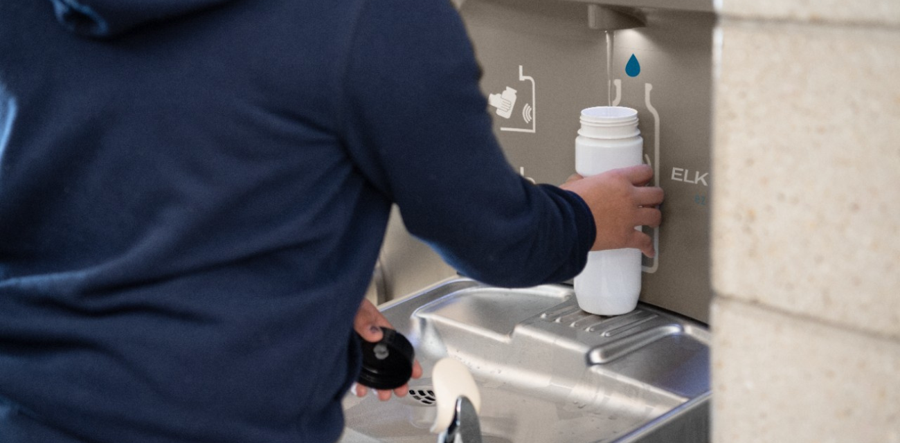 A child fills up their water bottle at a water station. (Photo courtesy of Elkay)