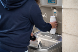 A child fills up their water bottle at a water station. (Photo courtesy of Elkay)