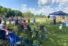 A man speaks about PFAS fighter AJ Birkbeck at his memorial in Rockford (Photo courtesy of Lynn McIntosh)