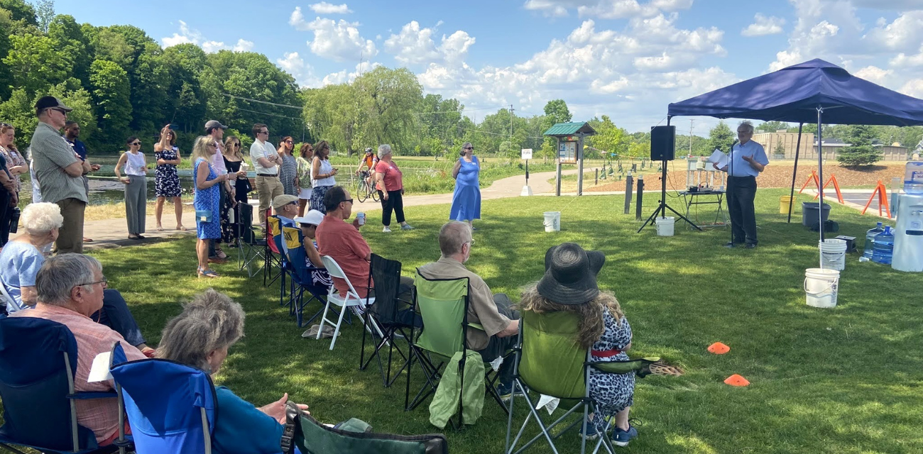 A man speaks about PFAS fighter AJ Birkbeck at his memorial in Rockford (Photo courtesy of Lynn McIntosh)