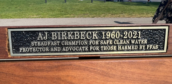 A park bench memorializes PFAS fighter AJ Birkbeck (Photo courtesy of Lynn McIntosh)