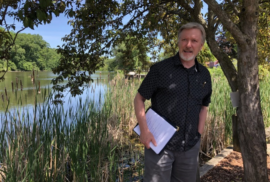 AJ Birkbeck gives a talk about PFAS at the Rogue River (Photo courtesy of MLive)