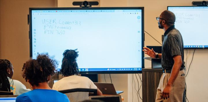 An employee of the Green Door Initiative prepares students for the class ahead