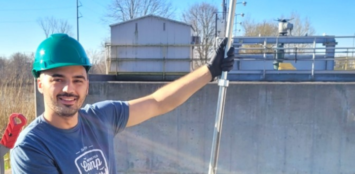 Ethan Coffin poses for a photo with his foam measuring device at Kalamazoo's watewater treatment plant (Photo courtesy of Ethan Coffin)