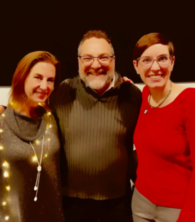 Jennifer McKay, Conan Smith and Melissa DeSimone pose for a picture at a holiday party.