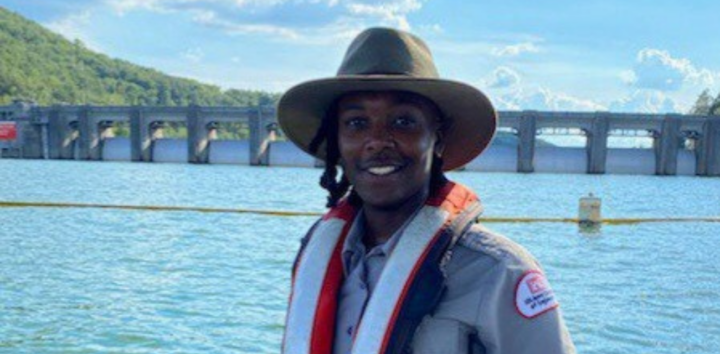 Oya Michelle-Watson stands in front of a dam