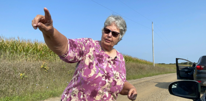 Pam Taylor points to something off camera on a Lenawee County dirt road (Photo courtesy of Midstory)