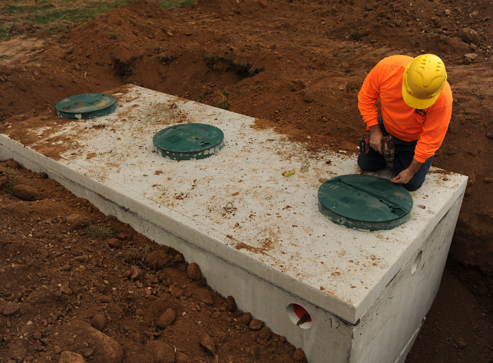 A man installs a septic tank