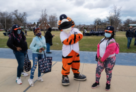 Detroit kids pose for a picture with Paws, the Detroit Tigers mascot, at Skinner Park. (Photo courtesy of the Detroit Tigers)