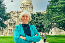 Dr. Joan Rose, water researcher, crosses her arms in the yard of the Michigan Capitol