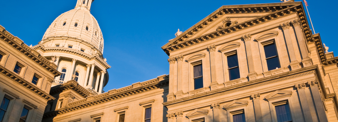 Michigan's Capitol building pictured at a unqiue angle on a bright day