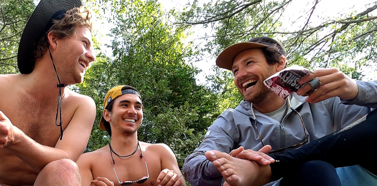 The team behind the movie 'Troubled Water' laugh as they rest from a day's paddle on Lake Michigan. (Photo courtesy of Troubled Water)