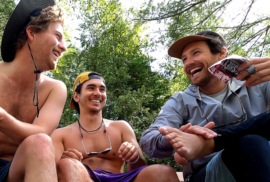 The team behind the movie 'Troubled Water' laugh as they rest from a day's paddle on Lake Michigan. (Photo courtesy of Troubled Water)