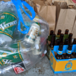 Vernors soda cans and Belle's Oberon bottles sit grouped in a bag and organizer, respectively, awaiting recycling