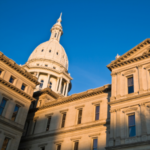 Michigan's Capitol building pictured at a unqiue angle on a bright day