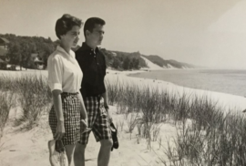 A woman and man stand atop a dune at Macatawa Beach. (Photo courtesy of the Archives of Michigan, 1962)