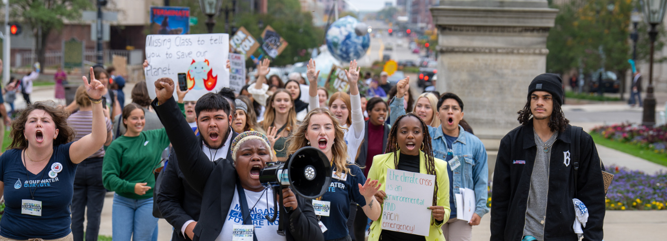 Protestors walk in downtown Lansing, calling for climate action. (Photo courtesy of Michigan Energy, Michigan Jobs).