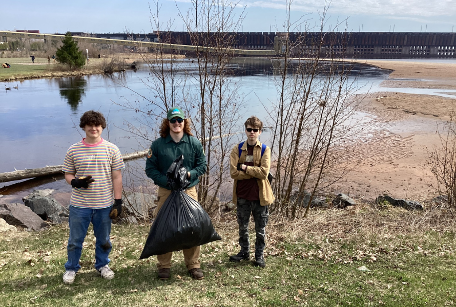 People clean up litter near water in the Upper Peninsula (Photo courtesy of Superior Watershed Partnership & Land Conservancy)