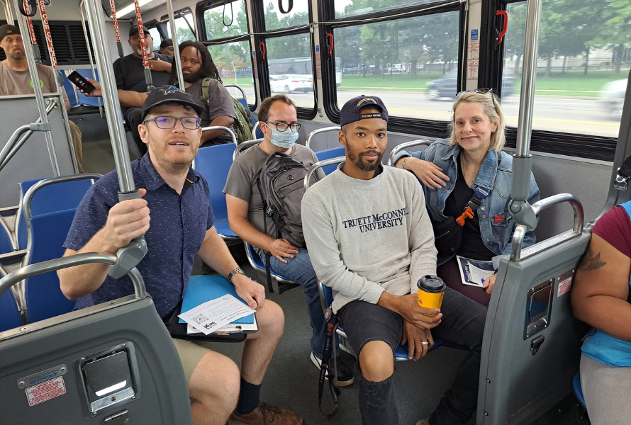 Transit advocates, transit riders and elected officials pose for a photo on a Metro Detroit bus. (Photo courtesy of Transportation Riders United.)