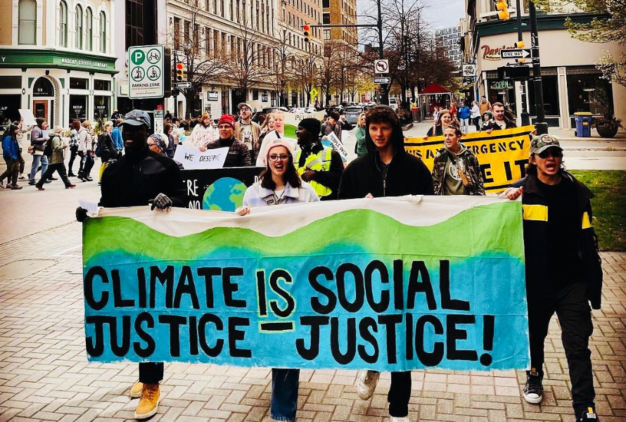 Protestors hold a sign proclaiming climate justice is social justice. (Photo courtesy of Grand Rapids Climate Coalition.)