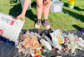 A volunteer dumps out trash collected at Lakeside Beach in Port Huron. (Photo courtesy of Friends of the St. Clair River)