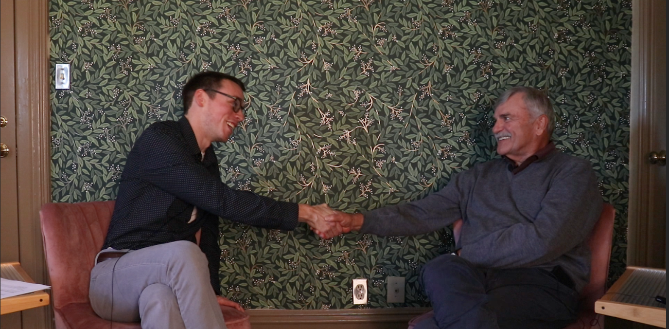 Beau Brockett, left, and Bill Rustem shake hands after recording a podcast episode about Michigan's Bottle Bill.