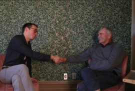 Beau Brockett, left, and Bill Rustem shake hands after recording a podcast episode about Michigan's Bottle Bill.