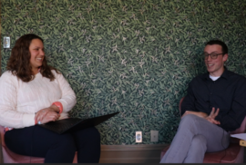 Emily Smith and Beau Brocket smile while talking about dunes for a podcast episode.