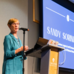 Sandy Sorini Elser speaks to a crowd after receiving the 2024 Petoskey Prize at Crystal Mountain in Thompsonville. (Photo by Beau Brockett.)