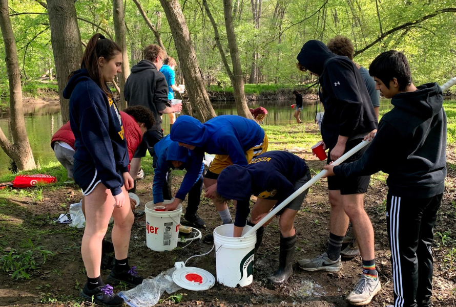 Haslett Middle School students release salmon into Red Cedar River and its watershed. (Photo courtesy of MidMichigan Environmental Action Council.)