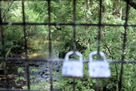 Two locks are hooked on a Macomb Orchard Trail bridge passing over the Coon Creek in Armada