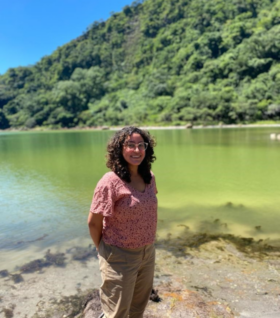 Paola Rivera Gonzalez poses in front of water and trees in El Salvador. (Photo courtesy of Paola Rivera Gonzalez.)