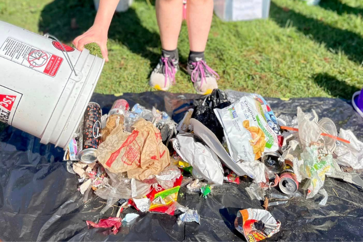 A volunteer dumps out trash collected at Lakeside Beach in Port Huron. (Photo courtesy of Friends of the St. Clair River)