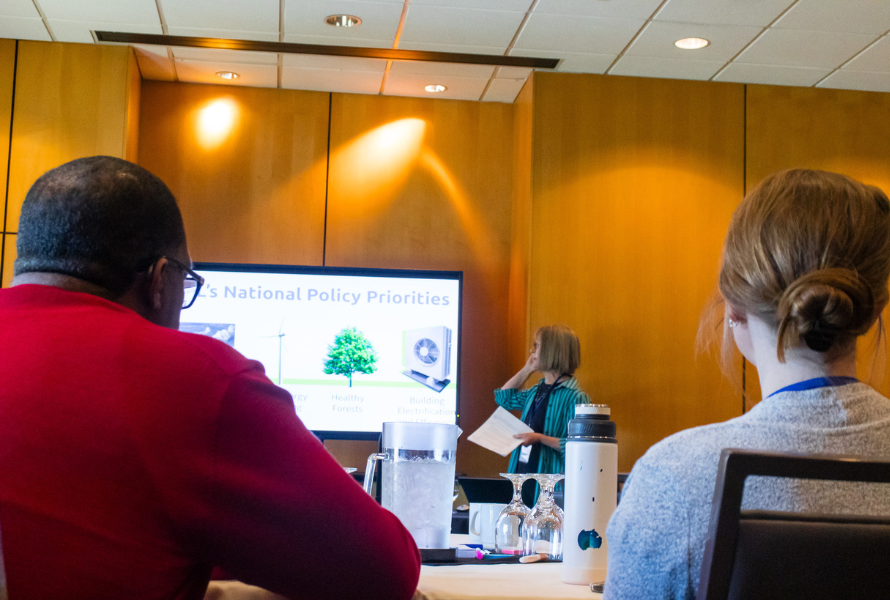 Galen Hardy, left, and Ellen Vial listen to Linda Racine talk about building bipartisan support for climate action. (Photo by Beau Brockett)