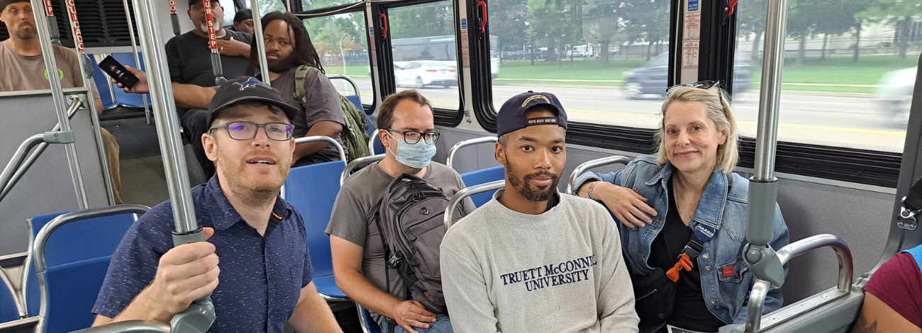 Transit advocates, transit riders and elected officials pose for a photo on a Metro Detroit bus. (Photo courtesy of Transportation Riders United.)