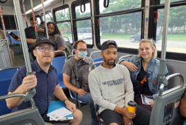 Transit advocates, transit riders and elected officials pose for a photo on a Metro Detroit bus. (Photo courtesy of Transportation Riders United.).jpg