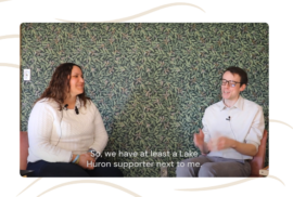 Emily Smith and Beau Brocket smile while talking about dunes for a podcast episode.