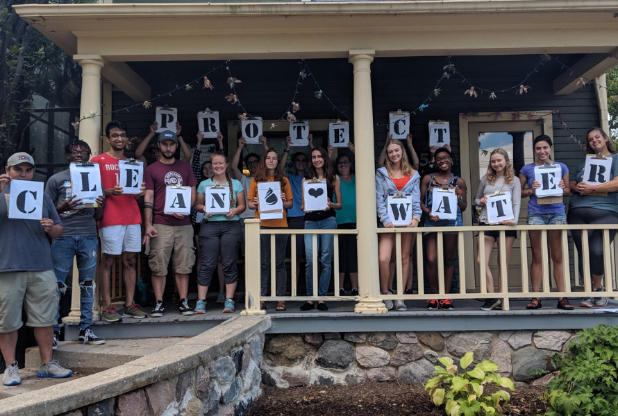 People hold letters that spell "Protect clean water" on a front porch. (Photo courtesy of Clean Water Action - Michigan)